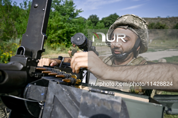 A fighter of the Separate Anti-Aircraft Machine Gun Battalion, who is providing air cover for the unmanned aerial vehicles and destroying ta...