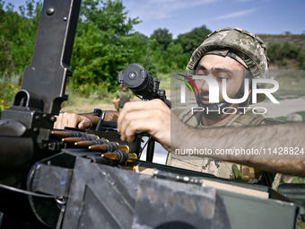 A fighter of the Separate Anti-Aircraft Machine Gun Battalion, who is providing air cover for the unmanned aerial vehicles and destroying ta...