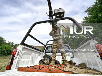 A fighter of the Separate Anti-Aircraft Machine Gun Battalion, who is providing air cover for the unmanned aerial vehicles and destroying ta...