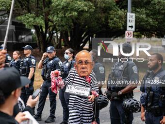 Pro-Palestinian activists demonstrate near the Watergate hotel ahead of the visit of Israeli Prime Minister Benjamin Netanyahu in Washington...