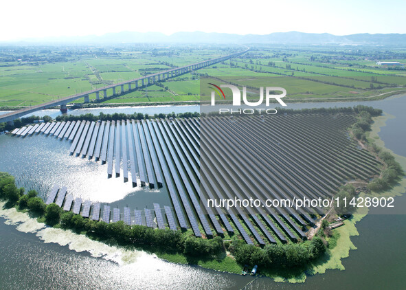 A 20MW distributed photovoltaic power station of the fishery-solar hybrid project is being shown in Xiage town of Chaohu city, in Chaohu, Ch...