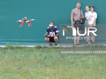 A participant in the 2nd Drone Racing Tournament by the Federation of Military Technological Sports of Ukraine is flying a drone in Bilohoro...