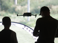 A man is flying a DJI drone during the 2nd Drone Racing Tournament by the Federation of Military Technological Sports of Ukraine in Bilohoro...