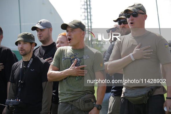 Participants in the 2nd Drone Racing Tournament by the Federation of Military Technological Sports of Ukraine are singing the national anthe...