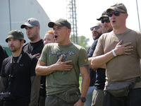 Participants in the 2nd Drone Racing Tournament by the Federation of Military Technological Sports of Ukraine are singing the national anthe...