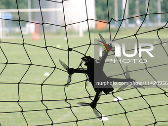 A drone is flying at the finish line during the 2nd Drone Racing Tournament by the Federation of Military Technological Sports of Ukraine in...