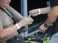 A participant in the 2nd Drone Racing Tournament by the Federation of Military Technological Sports of Ukraine is attaching a grenade to the...