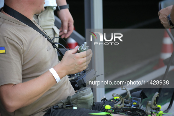 A participant in the 2nd Drone Racing Tournament by the Federation of Military Technological Sports of Ukraine is attaching a grenade to the...