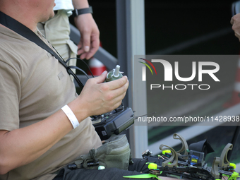 A participant in the 2nd Drone Racing Tournament by the Federation of Military Technological Sports of Ukraine is attaching a grenade to the...