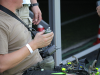 A participant in the 2nd Drone Racing Tournament by the Federation of Military Technological Sports of Ukraine is attaching a grenade to the...