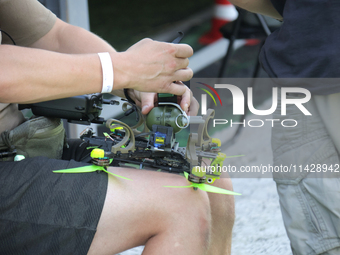 A participant in the 2nd Drone Racing Tournament by the Federation of Military Technological Sports of Ukraine is attaching a grenade to the...