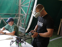 A participant in the 2nd Drone Racing Tournament by the Federation of Military Technological Sports of Ukraine is setting up a drone in Bilo...