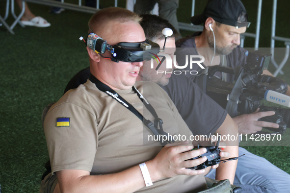 A participant in the 2nd Drone Racing Tournament by the Federation of Military Technological Sports of Ukraine is flying a drone in Bilohoro...