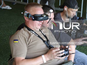 A participant in the 2nd Drone Racing Tournament by the Federation of Military Technological Sports of Ukraine is flying a drone in Bilohoro...