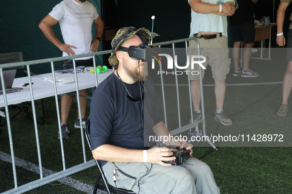 A participant in the 2nd Drone Racing Tournament by the Federation of Military Technological Sports of Ukraine is flying a drone in Bilohoro...