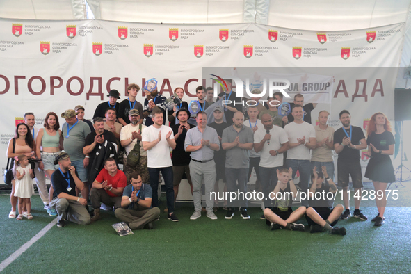 Participants in the 2nd Drone Racing Tournament by the Federation of Military and Technological Sports of Ukraine are posing for a photo in...