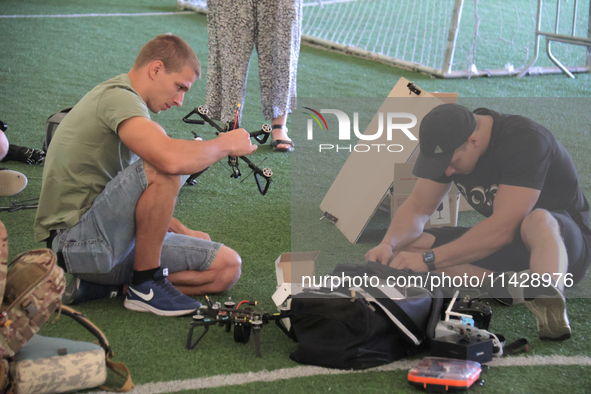 Participants in the 2nd Drone Racing Tournament by the Federation of Military Technological Sports of Ukraine are setting up drones in Biloh...