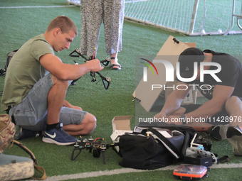 Participants in the 2nd Drone Racing Tournament by the Federation of Military Technological Sports of Ukraine are setting up drones in Biloh...