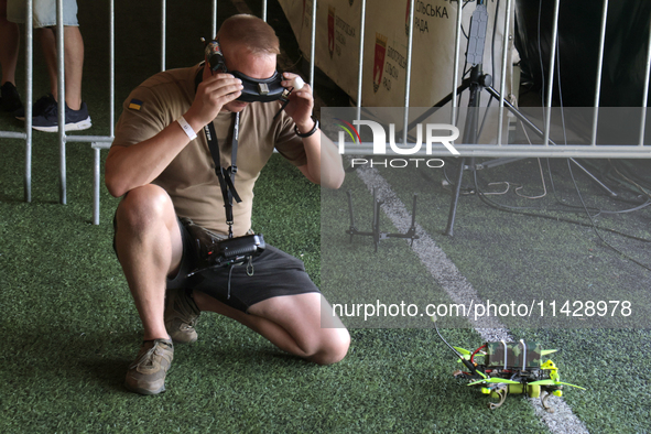 A participant in the 2nd Drone Racing Tournament by the Federation of Military and Technological Sports of Ukraine is getting ready to fly a...