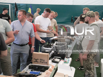 Visitors are looking at the items of the exhibition held as part of the 2nd Drone Racing Tournament by the Federation of Military and Techno...