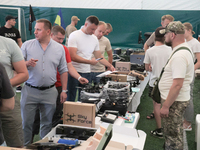 Visitors are looking at the items of the exhibition held as part of the 2nd Drone Racing Tournament by the Federation of Military and Techno...