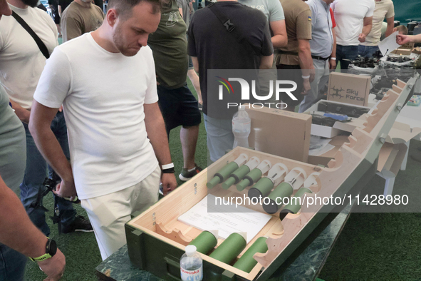 A man is looking at the drone bombs during the exhibition held as part of the 2nd Drone Racing Tournament by the Federation of Military and...