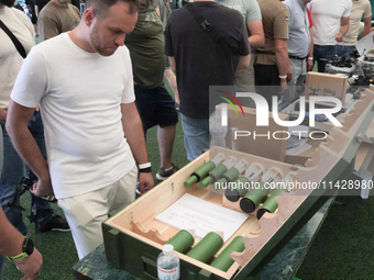 A man is looking at the drone bombs during the exhibition held as part of the 2nd Drone Racing Tournament by the Federation of Military and...