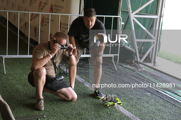 A participant in the 2nd Drone Racing Tournament by the Federation of Military and Technological Sports of Ukraine is getting ready to fly a...