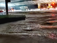 Vehicles are driving in a flooded area after heavy rain in Zhengzhou, China, on July 22, 2024. (