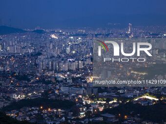 An evening scene of Seoul's downtown is being viewed from Bugaksan in Seoul, South Korea. Bugaksan is a mountain in the north of Seoul, Sout...