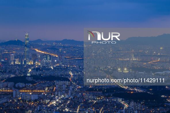 An evening view of Seoul's east side and Lotte World Tower is being seen from Namhansanseong in Gwangju, South Korea. Namhansanseong is a hi...