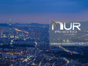 An evening view of Seoul's east side and Lotte World Tower is being seen from Namhansanseong in Gwangju, South Korea. Namhansanseong is a hi...