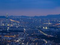 An evening view of Seoul's east side and Lotte World Tower is being seen from Namhansanseong in Gwangju, South Korea. Namhansanseong is a hi...