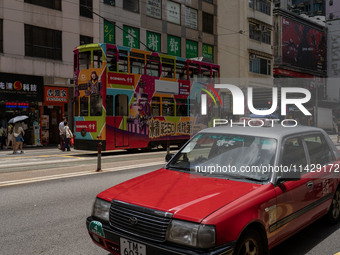 A taxi cab is driving in Hong Kong, China, on July 22, 2024. (