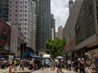 People are crossing the road in Hong Kong, China, on July 22, 2024. (