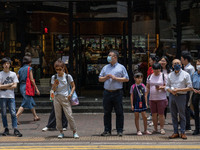 People are crossing the road in Hong Kong, China, on July 22, 2024. (