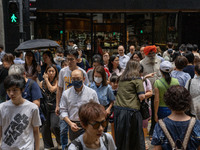 People are crossing the road in Hong Kong, China, on July 22, 2024. (