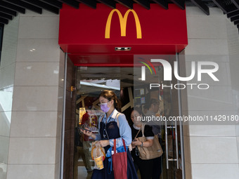 People are exiting a McDonald's in Hong Kong, on July 22, 2024. (