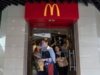 People are exiting a McDonald's in Hong Kong, on July 22, 2024. (