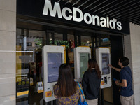 People are ordering from machines at a McDonald's in Hong Kong, on July 22, 2024. (