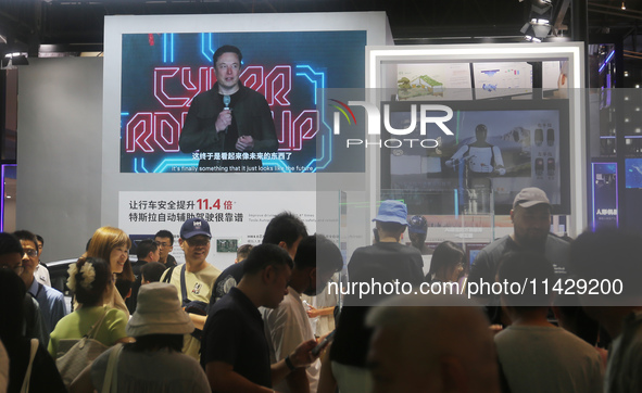 Visitors are viewing Tesla's humanoid robot Optimus Prime II at WAIC in Shanghai, China, on July 7, 2024. 