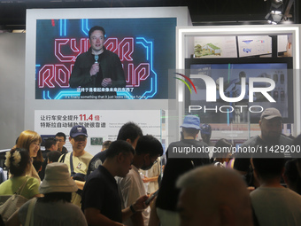 Visitors are viewing Tesla's humanoid robot Optimus Prime II at WAIC in Shanghai, China, on July 7, 2024. (