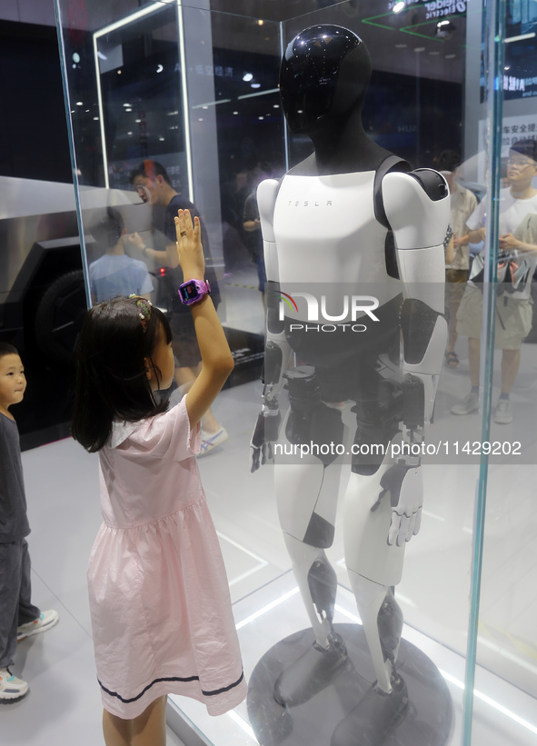 Visitors are viewing Tesla's humanoid robot Optimus Prime II at WAIC in Shanghai, China, on July 7, 2024. 