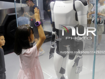 Visitors are viewing Tesla's humanoid robot Optimus Prime II at WAIC in Shanghai, China, on July 7, 2024. (