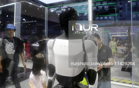 Visitors are viewing Tesla's humanoid robot Optimus Prime II at WAIC in Shanghai, China, on July 7, 2024. 