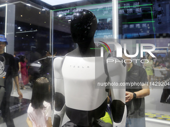 Visitors are viewing Tesla's humanoid robot Optimus Prime II at WAIC in Shanghai, China, on July 7, 2024. (