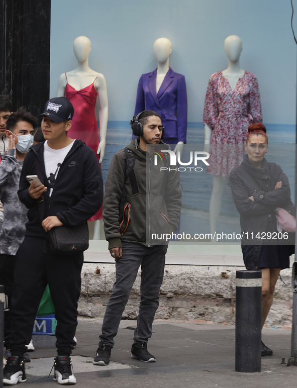 A view of passers-by in the centre of Mexico City, Mexico, on Monday, after Mexico City is reaching a record temperature of 34.2 degrees Cel...