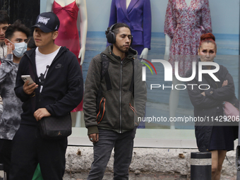 A view of passers-by in the centre of Mexico City, Mexico, on Monday, after Mexico City is reaching a record temperature of 34.2 degrees Cel...