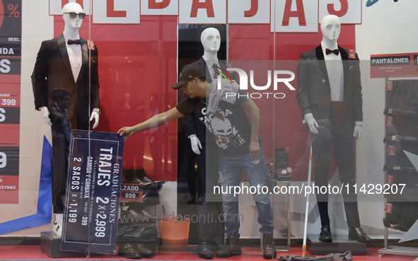 A person is fixing a display in downtown Mexico City.

After Mexico City reached a record temperature of 34.2 degrees Celsius in recent mont...