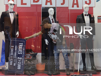 A person is fixing a display in downtown Mexico City.

After Mexico City reached a record temperature of 34.2 degrees Celsius in recent mont...